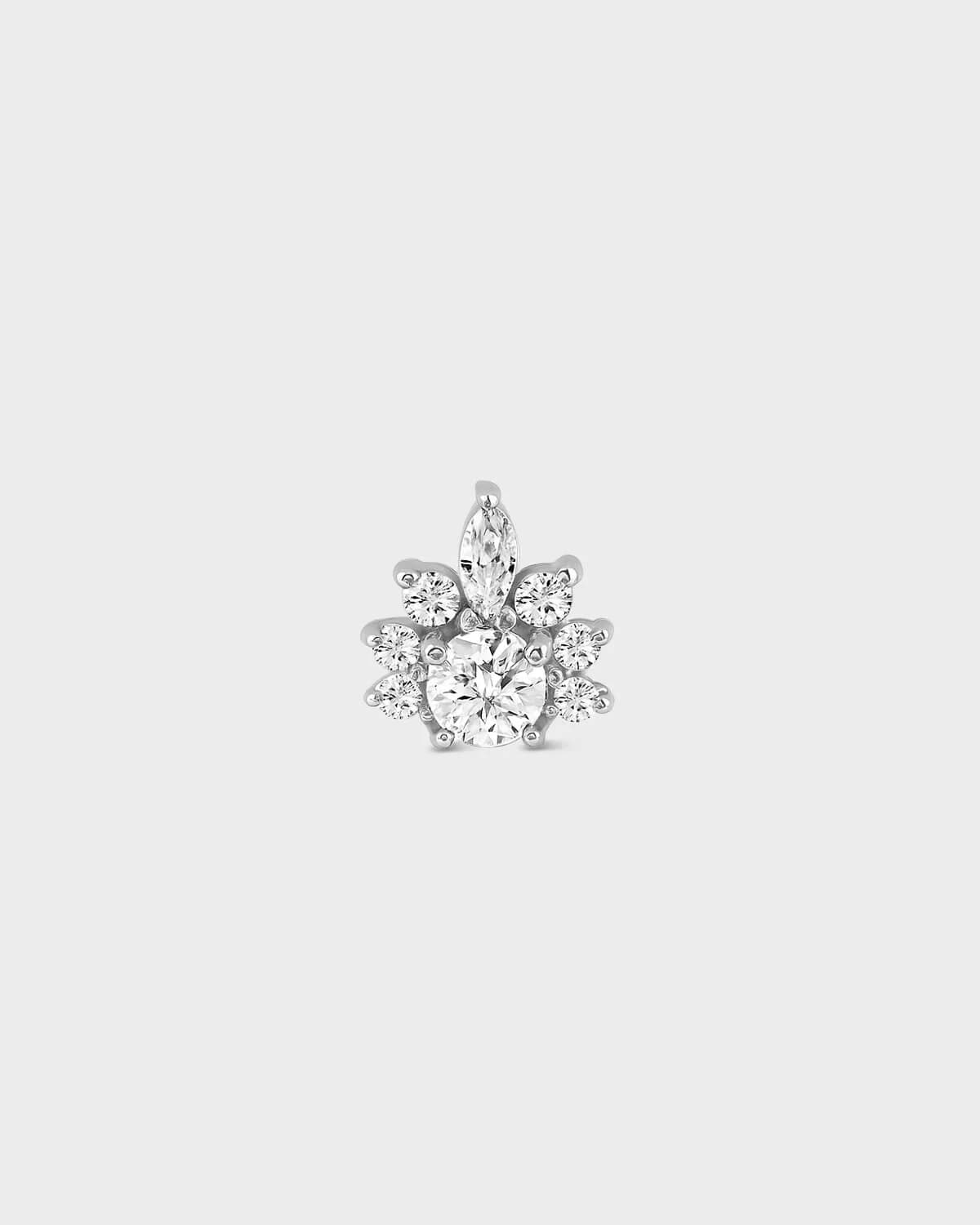Silver earring with clear gemstones on a white background